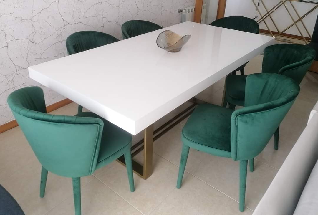 White table with green velvet chairs